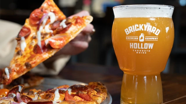Pizza and a glass of beer.