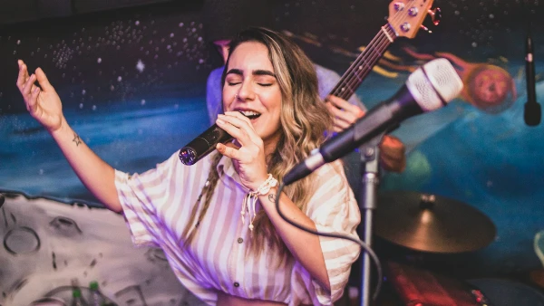 A woman singing on stage.