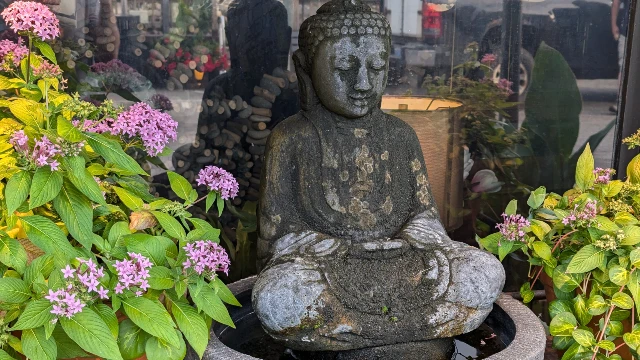 A buddha statue in front of Perkins Cove Pottery Shop.